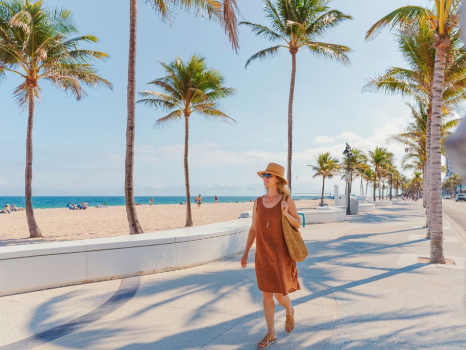 Woman walking along a beachfront promenade in Fort Lauderdale Florida US