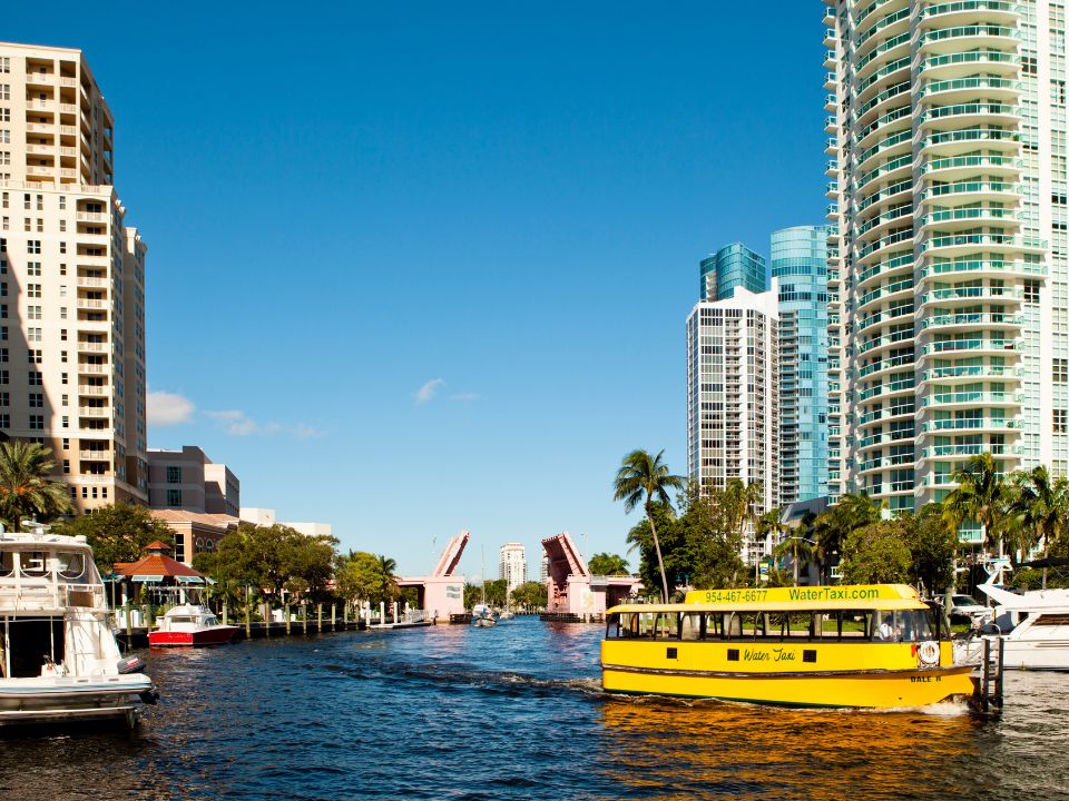 A water taxi navigates on the New River in Fort Lauderdale in the morning